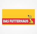 Gelbes Logo mit rotem Schriftzug „DAS FUTTERHAUS“ und einer gelben Hundegrafik auf rotem Balken.