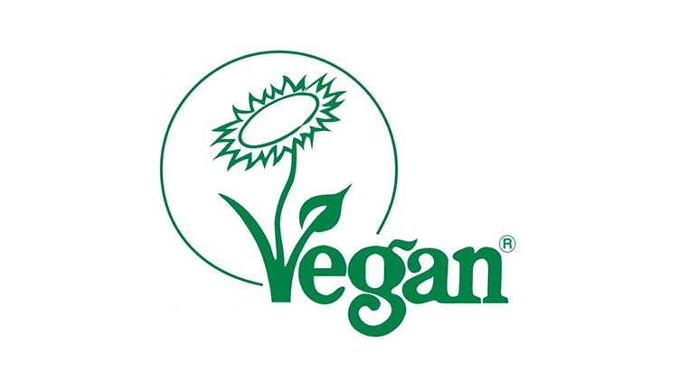 Grünes Vegan-Logo mit einer stilisierten Sonnenblume und dem Schriftzug Vegan sowie einem eingekreisten R-Zeichen.