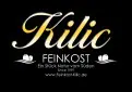 Schriftzug „Kilic Feinkost“ in gold und weiß auf schwarzem Hintergrund mit zwei stilisierten weißen Linien und weißen Schriftzeilen.