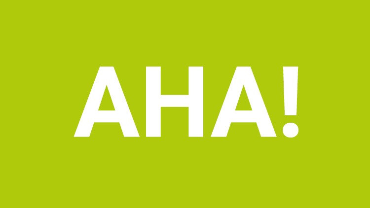 Grüner Hintergrund mit dem weißen Schriftzug „AHA!“ in Großbuchstaben zentriert dargestellt.