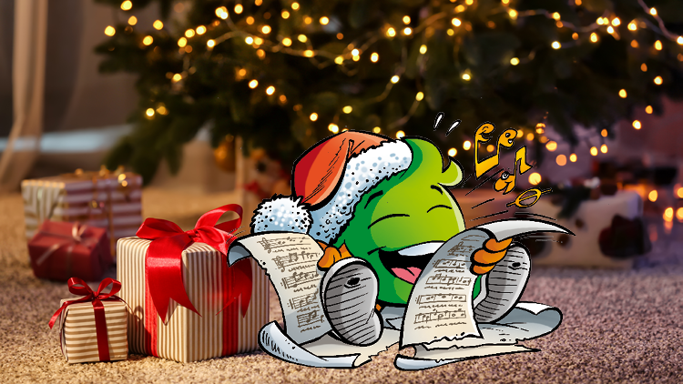 Das grüne kugelförmige Maskottchen Globini mit Weihnachtsmütze liest fröhlich eine Schriftrolle vor einem geschmückten Tannenbaum.