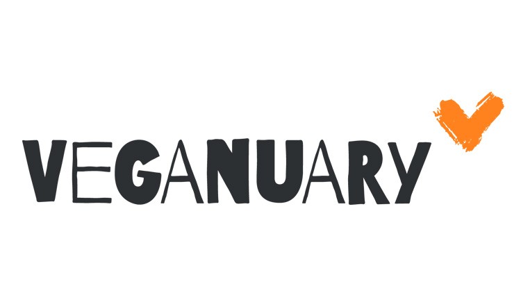 Schwarzer Schriftzug „VEGANUARY“ mit einem orangenen abgehakten Haken rechts oben als grafisches Element.