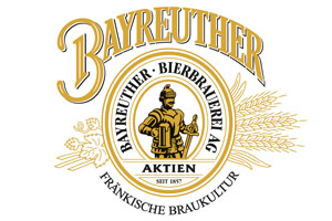 Ein goldenes Logo mit der Aufschrift „BAYREUTHER BIERBRAUEREI AG, AKTIEN, FRÄNKISCHE BRAUKULTUR“, einem Ritter und Ähren.