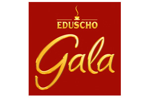 Auf rotem Hintergrund steht oben in Gelb „EDUSCHO“ mit einer kleinen dampfenden Tasse, darunter in geschwungenem Gold „Gala“.