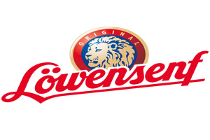 Logo mit blauem Löwenkopf und rotem Schriftzug Löwensenf, darüber der Text Original in einem goldenen Bogen.