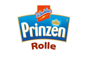 Das Bild zeigt das Logo der Marke „De Beukelaer Prinzen Rolle“ mit blauer Fläche, Krone und Schriftzug in Weiß und Braun.