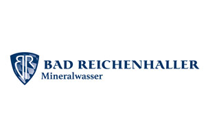 Blaues Wappen mit weißem „BR“, daneben blauer Schriftzug „BAD REICHENHALLER Mineralwasser“ auf weißem Hintergrund.