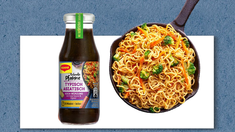Eine Glasflasche mit MAGGI-Soße „Schnelle Pfanne Typisch Asiatisch“ steht neben einer Pfanne mit gebratenen Nudeln und Gemüse.
