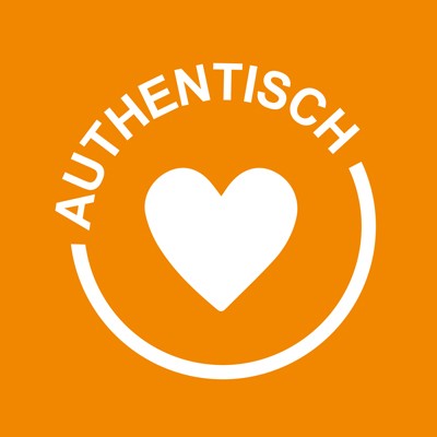 Ein weißes Herz auf orangefarbenem Hintergrund, umgeben von einem halben Kreis und dem Wort AUTHENTISCH in Großbuchstaben.