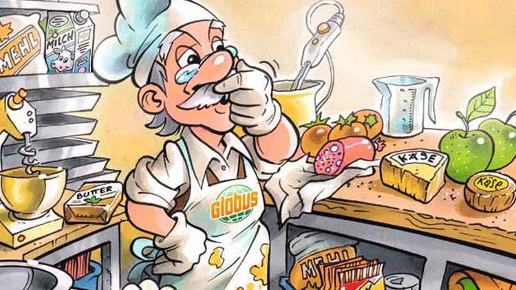 Ein lächelnder Professor Globus steht in einer Küche mit Lebensmitteln wie Käse, Wurst, Butter, Äpfeln und Backzutaten.