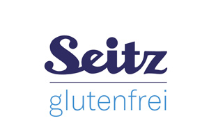 Das Bild zeigt das Logo der Marke Seitz mit dem Schriftzug „Seitz“ in Dunkelblau und „glutenfrei“ in Hellblau darunter.