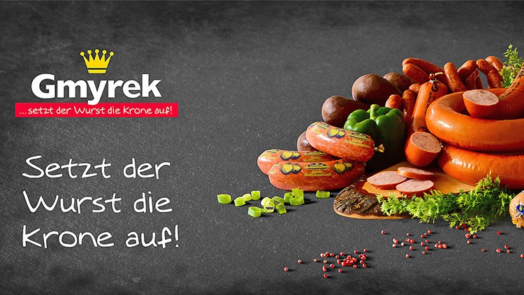 Auf einem schwarzen Untergrund liegen verschiedene Wurstsorten, Gemüse, Kräuter und ein Text: „Setzt der Wurst die Krone auf!“.