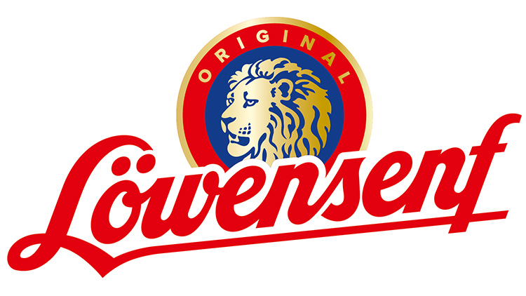 Ein sitzender Löwe in einem blauen Kreis mit rotem Rand, darunter der rote Schriftzug „Löwensenf Original“.