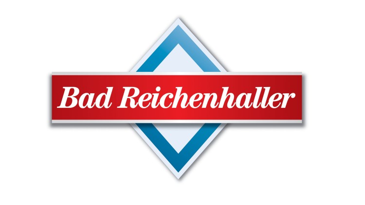 Logo mit rotem Band und weißem Schriftzug „Bad Reichenhaller“, dahinter ein blau-weißes Rautenmotiv.