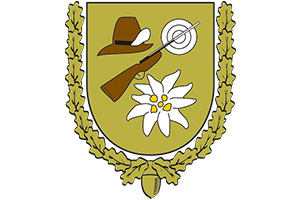 Ein gelbes Wappen mit Gewehr, Hut, Zielscheibe, Edelweiß und einem goldenen Eichenlaubkranz.