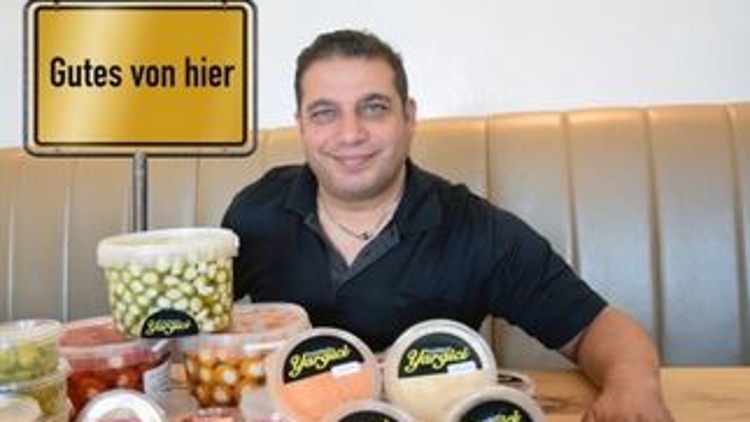 Verschiedene Plastikbehälter mit eingelegtem Gemüse und Aufschrift \